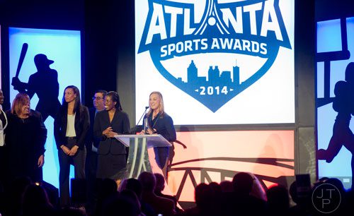 Mary Brock (right), accepts the award for Team of the Year for the Atlanta Dream during the 9th annual Atlanta Sports Awards at the Fox Theatre on Wednesday, March 5, 2014. 