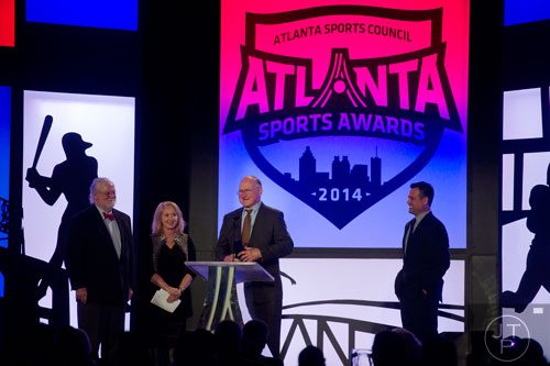 Tommy Nobus (center) receives the 2014 Lifetime Achievement Awardduring the 9th annual Atlanta Sports Awards at the Fox Theatre on Wednesday, March 5, 2014. 