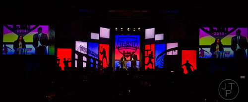 Atlanta Dream head coach Michael Cooper (right) and Heather Dade-Themelis present the award for Coach of the Year during the 9th annual Atlanta Sports Awards at the Fox Theatre on Wednesday, March 5, 2014. 