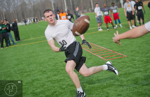 Jacob Ryan (80) is pitched a ball in a receiver drill during the first tryouts for the new Kennesaw State University football team at The Perch on campus on Saturday, March 22, 2014. 