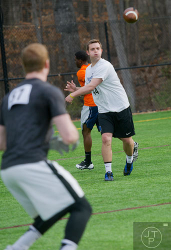 Potential quarterback Reeves Johnson (right) throws the football to Cullen McCrite in a receiver drill during the first tryouts for the new Kennesaw State University football team at The Perch on campus on Saturday, March 22, 2014.