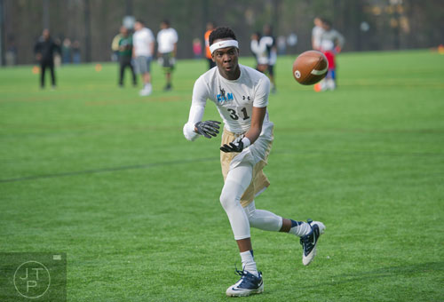 Marcus Fawole (31) lines up to catch the ball in a receiver drill during the first tryouts for the new Kennesaw State University football team at The Perch on campus on Saturday, March 22, 2014. 
