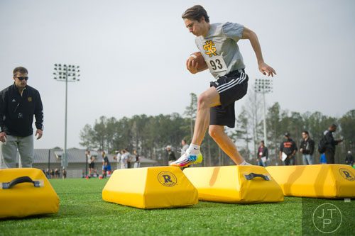 Oliver Wronowski (93) high steps over bags in a receiver drill during the first tryouts for the new Kennesaw State University football team at The Perch on campus on Saturday, March 22, 2014. 