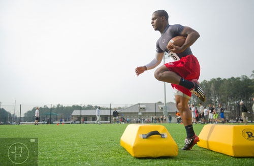 Ryan Godhigh high steps over bags in a receiver drill during the first tryouts for the new Kennesaw State University football team at The Perch on campus on Saturday, March 22, 2014. 