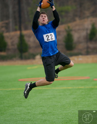 Troy Darr leaps into the air to catch a ball in a 45 posted speed turn drill during the first tryouts for the new Kennesaw State University football team at The Perch on campus on Saturday, March 22, 2014. 