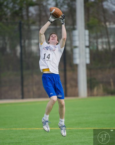 Jacob Butz stretches to catch a ball in a 45 posted speed turn drill during the first tryouts for the new Kennesaw State University football team at The Perch on campus on Saturday, March 22, 2014.