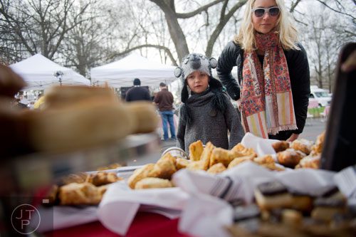 Hudson Jordan (left) and his mother Stephanie look at the baked goods for sale at the Cakes & Ale booth during the Freedom Farmers Market at the Carter Center in Atlanta on Saturday, March 1, 2014. 