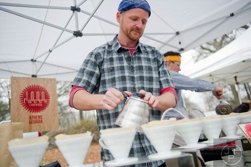 Ben Myers makes fresh cups of coffee at the 1,000 Faces Coffee booth during the Freedom Farmers Market at the Carter Center in Atlanta on Saturday, March 1, 2014. 