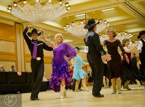 Anthony Ferrara (left) dances with partner Peggy Fisher during the Peach State Dance Festival at the Crown Plaza Ravinia hotel in Atlanta on Saturday, March 22, 2014.