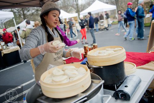 Hannah Chung steams buns at the Simply Seoul booth during the Freedom Farmers Market at the Carter Center in Atlanta on Saturday, March 1, 2014.