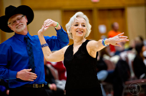 Linda Hunt (right) dances the triple two with her partner Wayne Tipton during the Peach State Dance Festival at the Crown Plaza Ravinia hotel in Atlanta on Saturday, March 22, 2014.