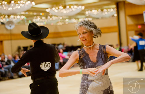 Sue Cicchetti (right) dances the triple two with her husband Richard during the Peach State Dance Festival at the Crown Plaza Ravinia hotel in Atlanta on Saturday, March 22, 2014. 