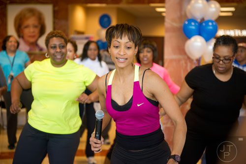 Andrea Riggs (center) leads a workout during Dr. Valerie Montgomery Rice's kickoff for her 12 week challenge to loose 15 inches at the Morehouse School of Medicine in Atlanta on Saturday, March 1, 2014. 