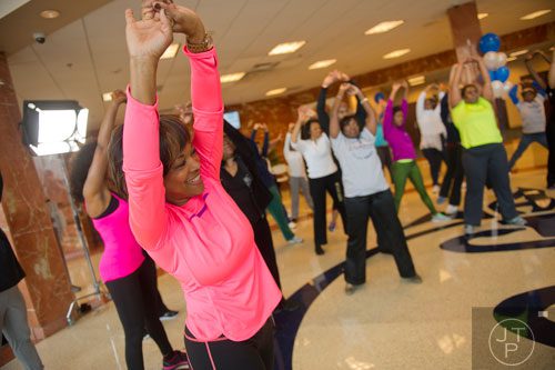 Dr. Valerie Montgomery Rice (left), Dean and Executive Vice President of the Morehouse School of Medicine in Atlanta, stretches after a short workout during the kickoff for her 12 week challenge to lose 15 inches on Saturday, March 1, 2014.