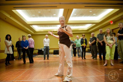 Instructor Beth Emerson (center) teaches her class the cha cha during the Peach State Dance Festival at the Crown Plaza Ravinia hotel in Atlanta on Saturday, March 22, 2014. 