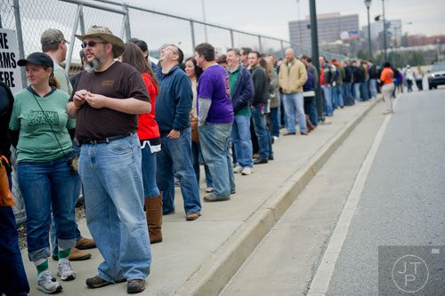  Jade Cress (left) and her husband Jeremy stand in line as they wait to enter the Beer, Bourbon & BBQ Festival at Atlantic Station in Atlanta on Saturday, March 1, 2014. 