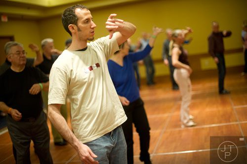 John Erdelt (left) learns steps to the cha cha during the Peach State Dance Festival at the Crown Plaza Ravinia hotel in Atlanta on Saturday, March 22, 2014.