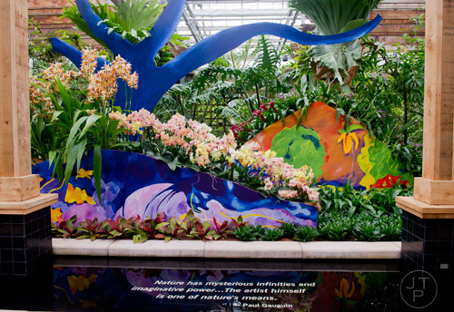 Orchids sit in bloom in the Paul Gauguin section of the Orchid Daze: Lasting Impressions installation at the Atlanta Botanical Garden's Fuqua Conservatory and Orchid Center on Tuesday, March 4, 2014.