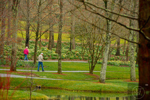 Edna Watson (left) and her husband Emory walk the pathways at Gibbs Gardens in Ball Ground on Friday, March 7, 2014. 