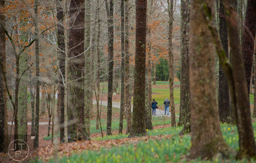 Marjorie Searcy (left) and her husband George walk the pathways at Gibbs Gardens in Ball Ground on Friday, March 7, 2014.