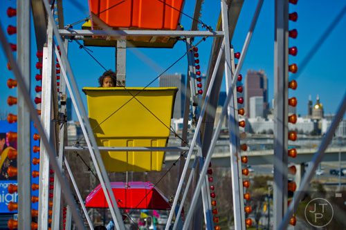 Arianna Harbor (left) looks out of her car as she rides the Expo Wheel during the Atlanta Fair at Turner Field on Saturday, March 8, 2014.