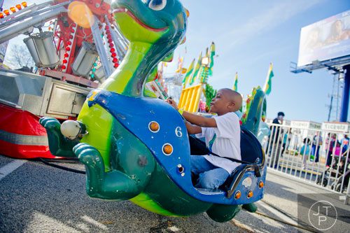 Leondre Sanders rides a dragon during the Atlanta Fair at Turner Field on Saturday, March 8, 2014. 