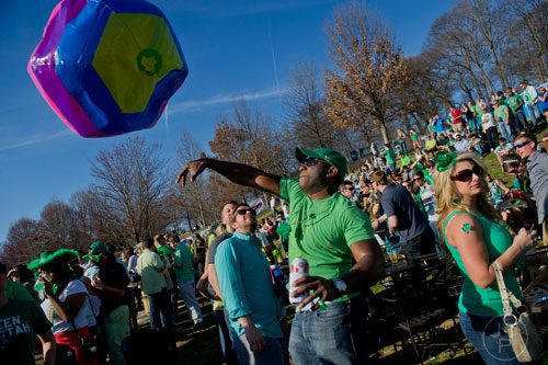 Michael Renwick (center) hits an inflatable ball into the air during the 4th annual Lepre*CON at Park Tavern in Atlanta on Saturday, March 8, 2014. 