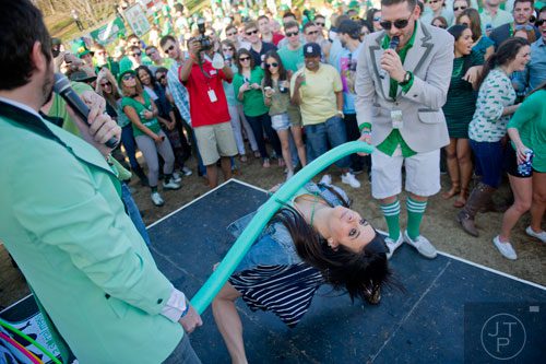 Lindsay Winn (center) competes in a limbo contest during the 4th annual Lepre*CON at Park Tavern in Atlanta on Saturday, March 8, 2014. 
