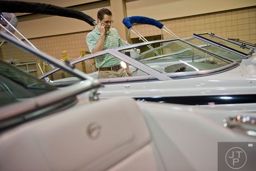 Paul Rowley looks at some of the boats on display during the Spring Into Summer Boat Show at the Gwinnett Center in Duluth on Sunday, March 9, 2014. 