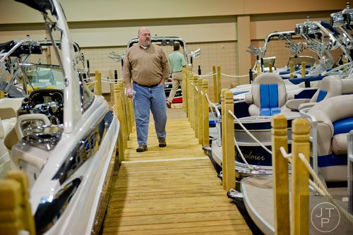 Michael Veach looks at some of the boats on display during the Spring Into Summer Boat Show at the Gwinnett Center in Duluth on Sunday, March 9, 2014. 