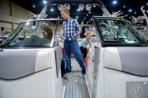 Bailey Fisher (left), her brother Ben and sister Abby check out one of the boats on display during the Spring Into Summer Boat Show at the Gwinnett Center in Duluth on Sunday, March 9, 2014. 