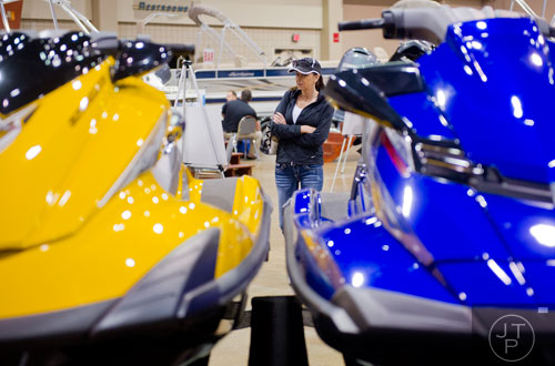 Sonya Little looks at jet skis sit on display during the Spring Into Summer Boat Show at the Gwinnett Center in Duluth on Sunday, March 9, 2014.