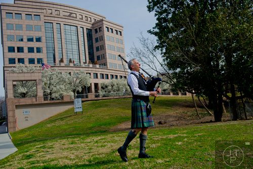 Robbie Rogers warms up his bagpipes before the start of the Atlanta St. Patrick's Day Parade on Saturday, March 15, 2014.