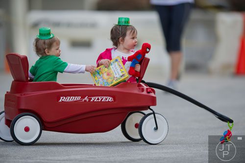 Crosby Conley (left) tries to steal a book from Katie Woods as they wait for the Atlanta St. Patrick's Day Parade to begin on Saturday, March 15, 2014. 