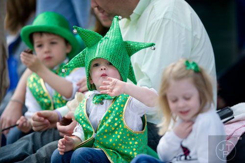 Cormac Wrenn (center) watches the Atlanta St. Patrick's Day Parade pass by on Peachtree St, on Saturday, March 15, 2014. 