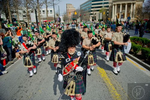 Don Bogue (center) leads the Atholl Highlanders Pipes & Drums down Peachtree St. during the Atlanta St. Patrick's Day Parade on Saturday, March 15, 2014. 