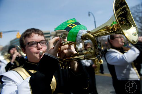 Ezra Jacobs (left) plays his trumpet during the Atlanta St. Patrick's Day Parade on Saturday, March 15, 2014. 