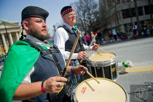 Anthony Green (left) and J.J. Hayden play their drums as the North Atlanta Pipes & Drums march down Peachtree St. during the Atlanta St. Patrick's Day Parade on Saturday, March 15, 2014. 