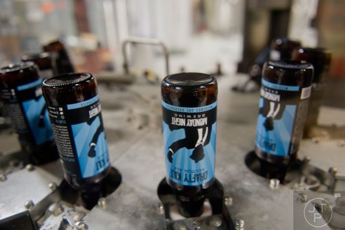 Beer bottle circulate through the bottling machine at Monday Night Brewing in Atlanta on Tuesday, February 18, 2014.