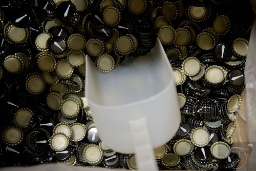 Bottle caps sit in a box waiting to be used at Monday Night Brewing in Atlanta on Tuesday, February 18, 2014.