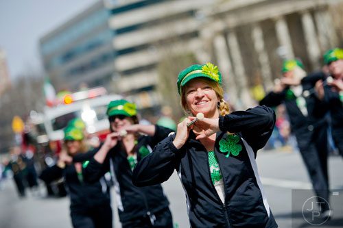 Patti Griffith (center) twirls her baton as the Twilight Twirlers make their way down Peachtree St. during the Atlanta St. Patrick's Day Parade on Saturday, March 15, 2014. 