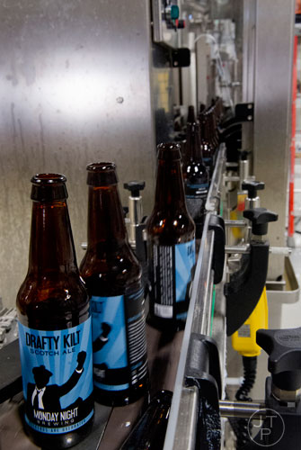 Empty bottles head into the bottling machine at Monday Night Brewing in Atlanta on Tuesday, February 18, 2014.