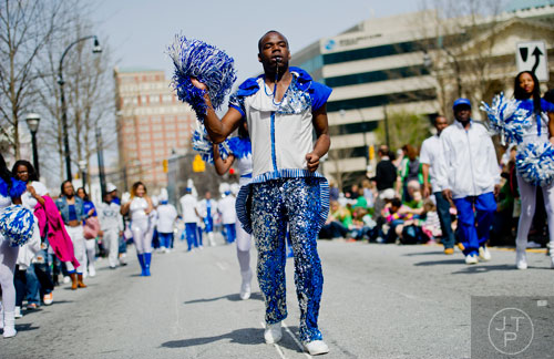 Jermaine Johnson (center) marches down Peachtree St. with the New Edition Marching Band during the Atlanta St. Patrick's Day Parade on Saturday, March 15, 2014. 