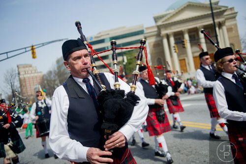 Greg McKellar plays his bagpipes as the John Mohr Mackintosh Pipes and Drums march down Peachtree St. during the Atlanta St. Patrick's Day Parade on Saturday, March 15, 2014. 