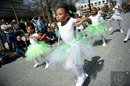 Ameera Tripplet (center) dances down Peachtree St. during the Atlanta St. Patrick's Day Parade on Saturday, March 15, 2014. 