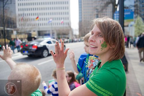  Jessica Kranich (right) holds her son Gavin as they watch the Atlanta St. Patrick's Day Parade on Saturday, March 15, 2014. 