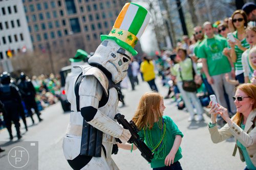 A stormtrooper from the 501st Legion has their photo taken with Charlotte Self by her mother Shalyn during the Atlanta St. Patrick's Day Parade on Saturday, March 15, 2014. 
