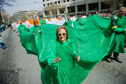 Aileen Hatcher (left) walks down Peachtree Street as part of the World's Largest Walking Irish Flag during the Atlanta St. Patrick's Day Parade on Saturday, March 15, 2014. 