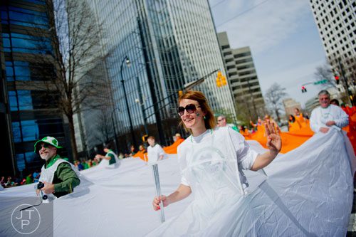 Heather Dziedzic walks down Peachtree Street as part of the World's Largest Walking Irish Flag during the Atlanta St. Patrick's Day Parade on Saturday, March 15, 2014. 