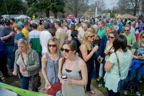 Meredith Dixon (right) and Amanda Reich talk to one of the pourers during the Roswell Beer Festival & Cornhole Tournament at historic Roswell square on Saturday, March 15, 2014. 